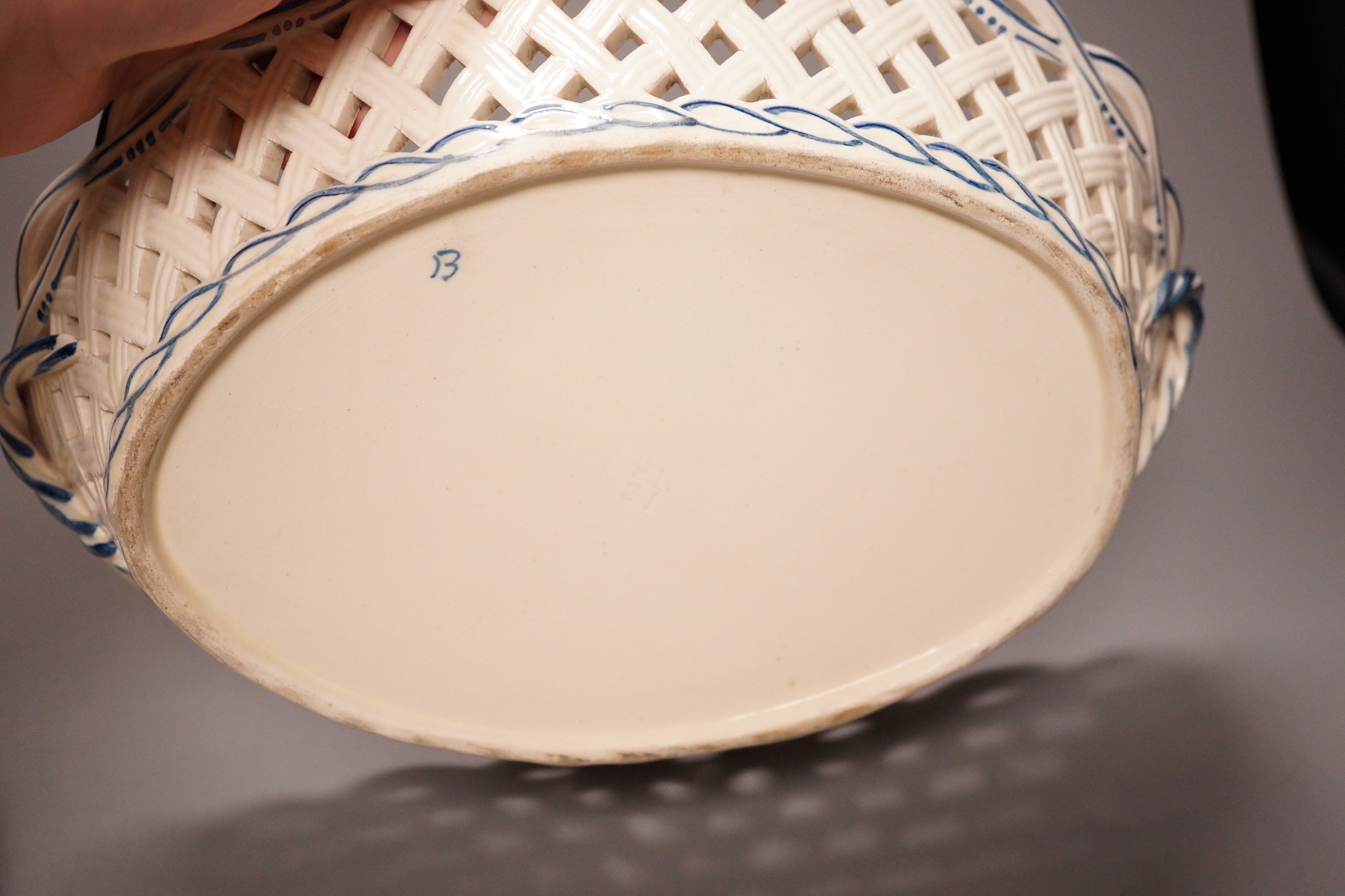 A Leeds creamware jar, a Delft armorial caddy, a Cantagalli maiolica plate and a creamware chestnut basket